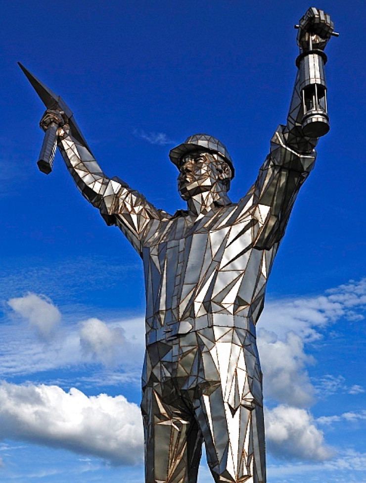 Jigger, the Brownhills Miner statue — pick and lamp raised against the sky